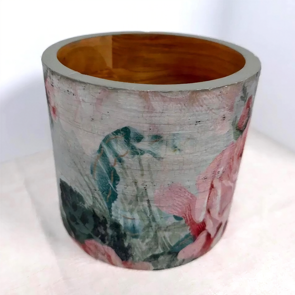a ceramic vase with a floral pattern on its surface.
