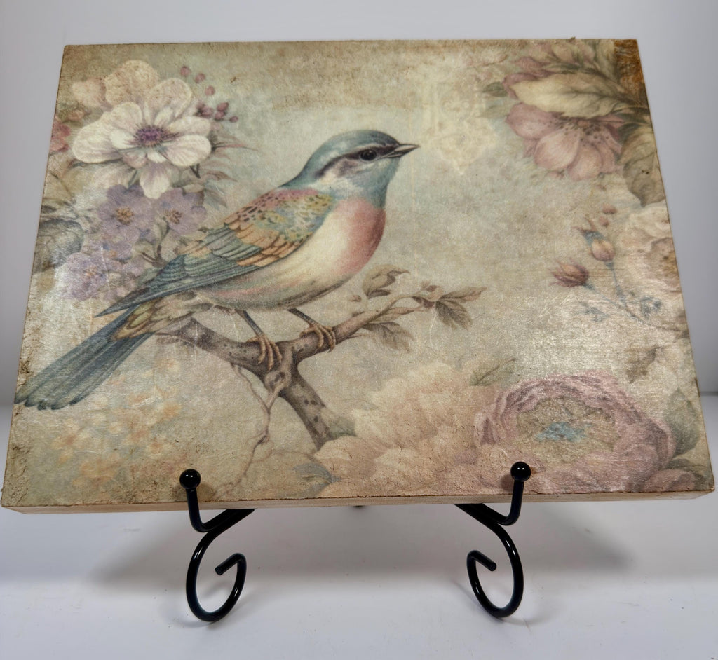 a painting of a colorful bird perched on a branch, surrounded by flowers and foliage.