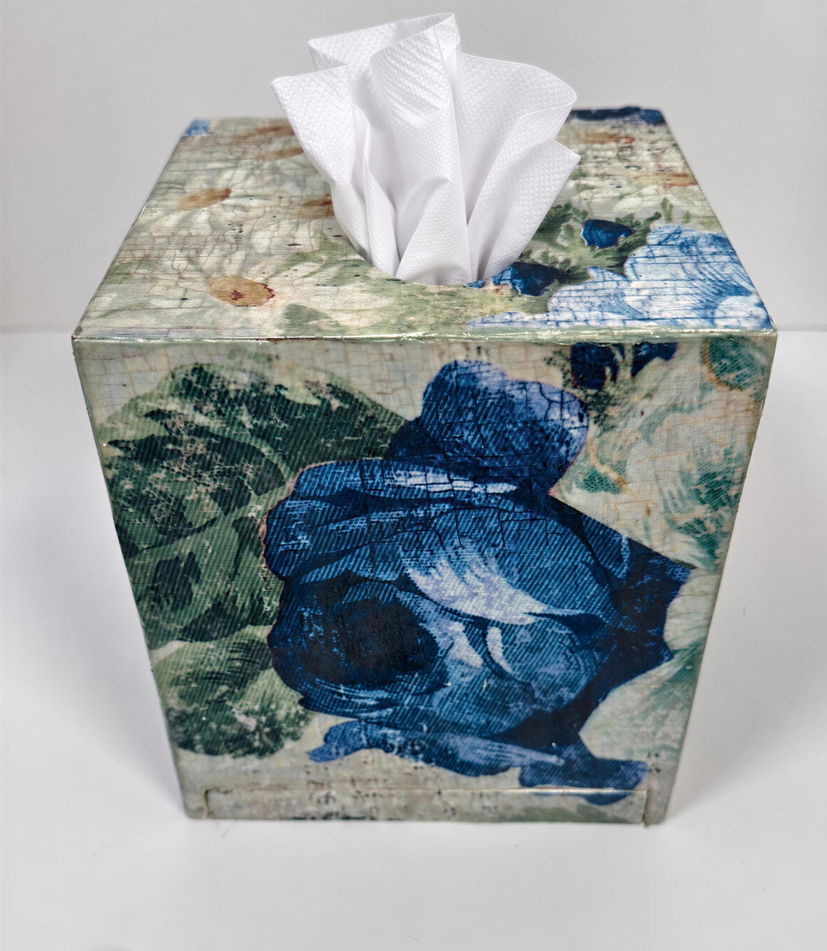 a decorative tissue box with a floral pattern on its surface.