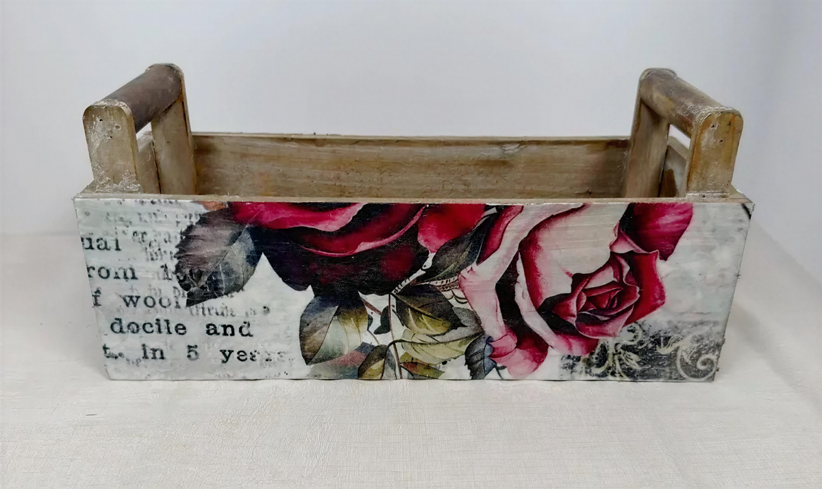 a wooden crate with a floral design on it.