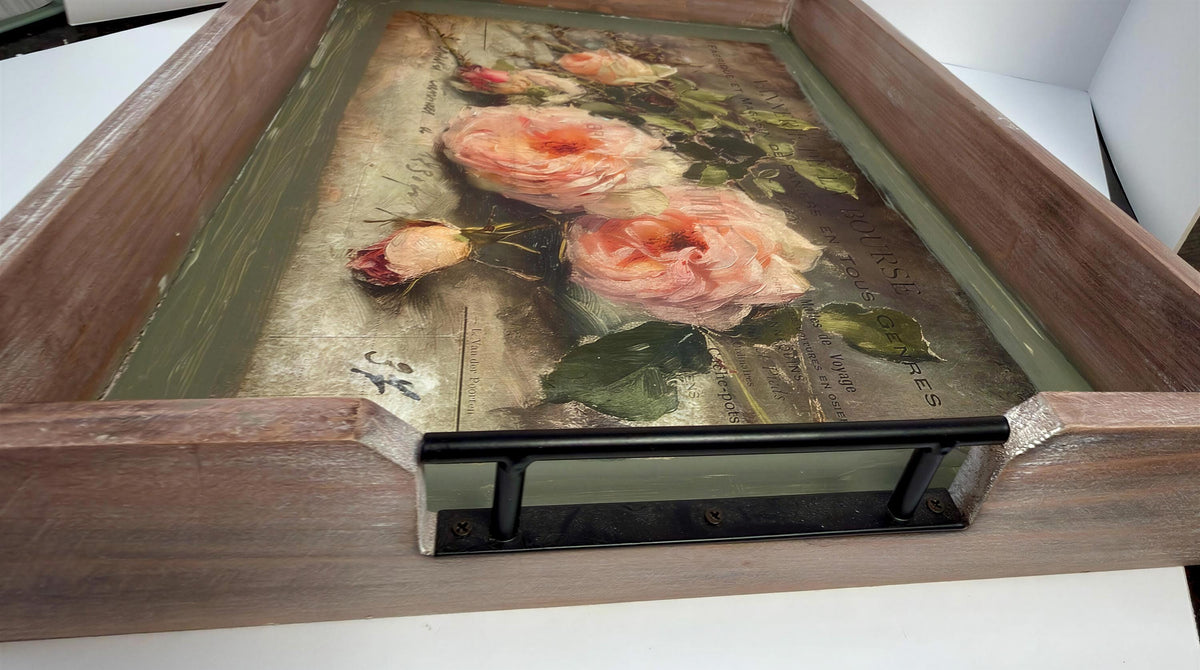 a wooden tray with a decorative floral design on it.