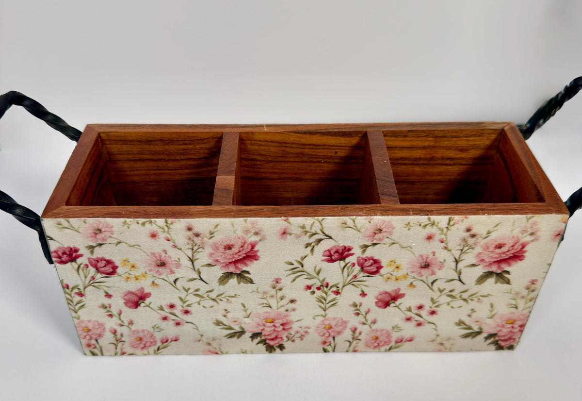 A wooden box with a floral pattern on its surface, featuring three compartments.