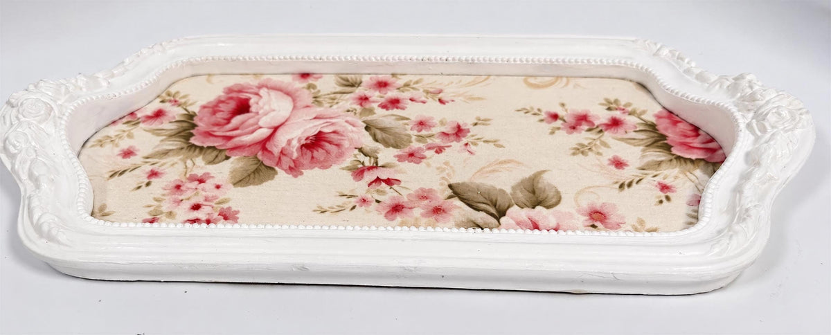 A white tray with a floral pattern on it.