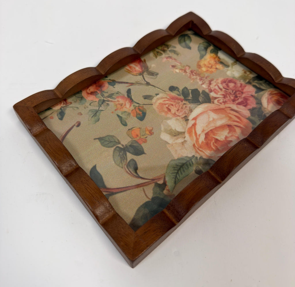 a wooden tray with a floral pattern on it.
