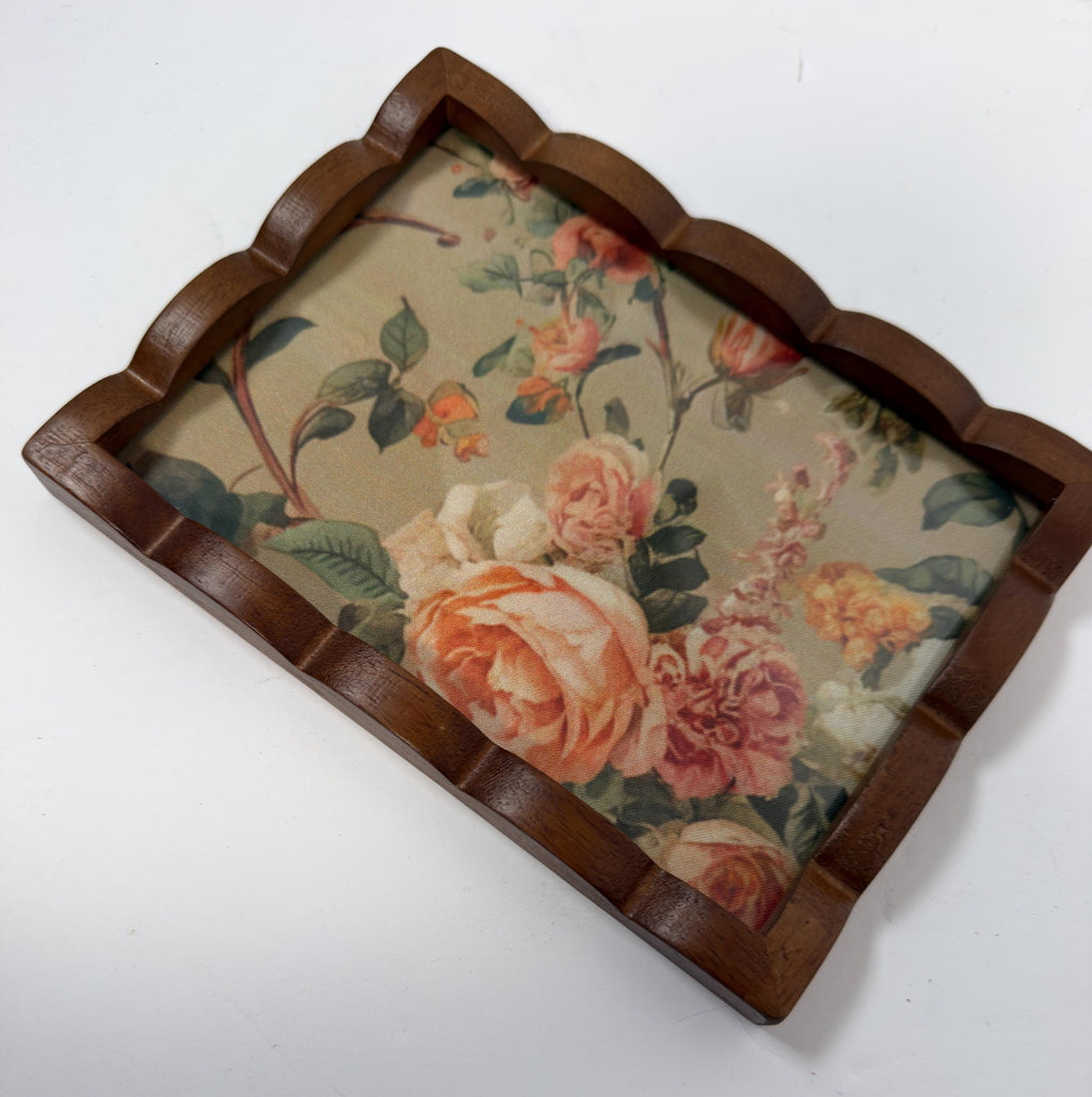 a wooden tray with a floral pattern on it.