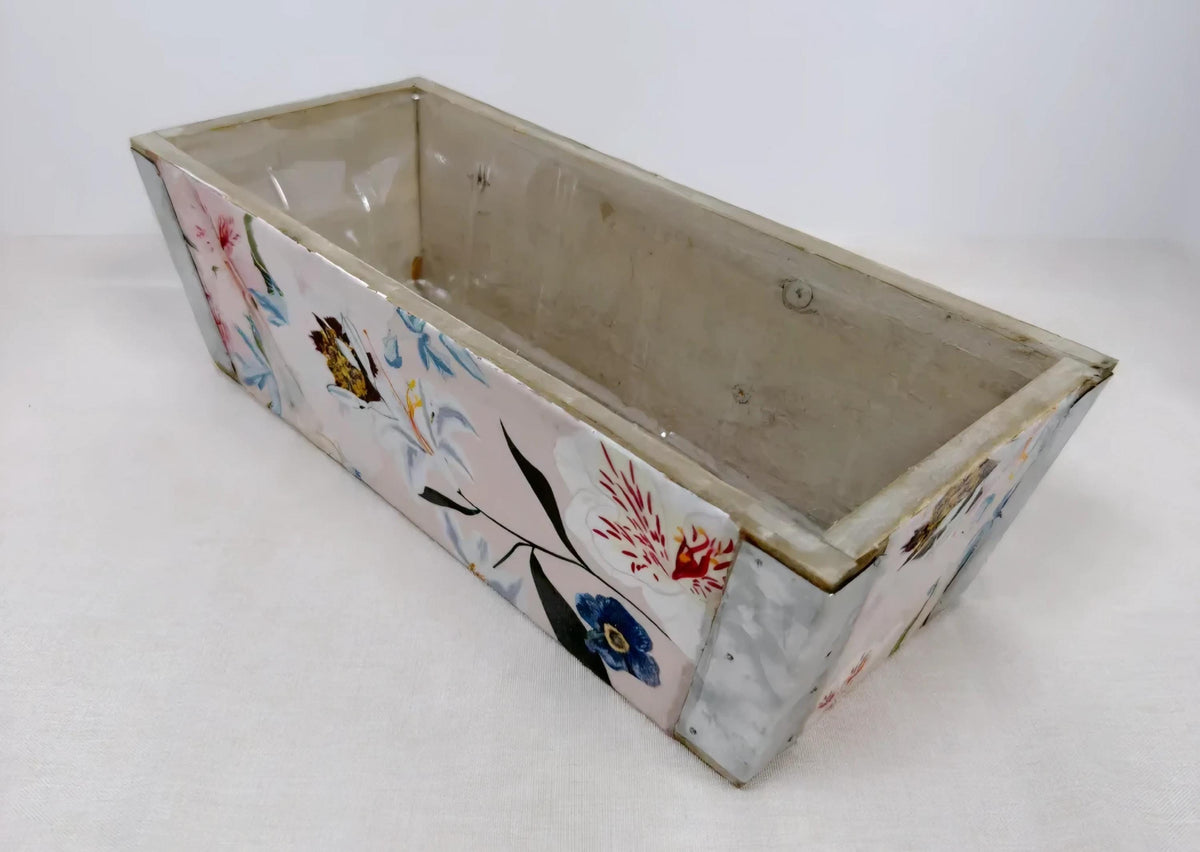A rectangular, empty flower-patterned box with a white background.
