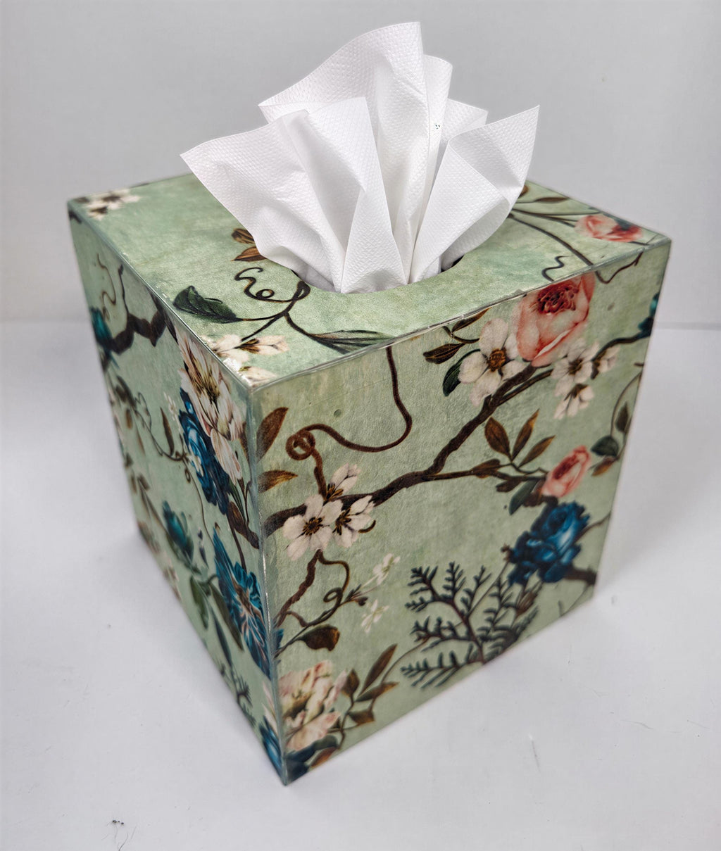 A decorative tissue box with a floral pattern on its surface.