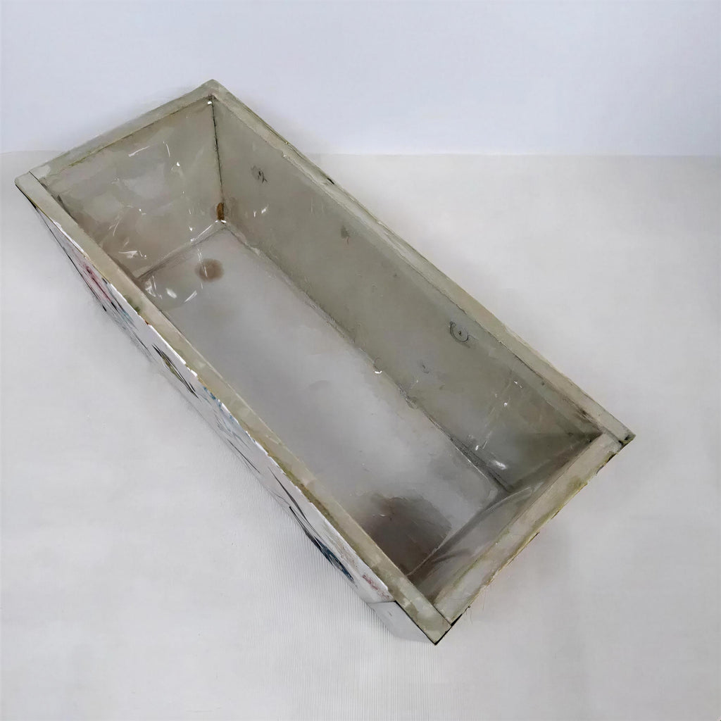 a rectangular, empty metal container with a white interior.