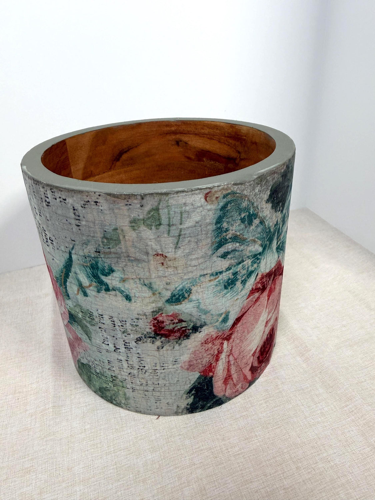 a round vase with a floral pattern on its surface.
