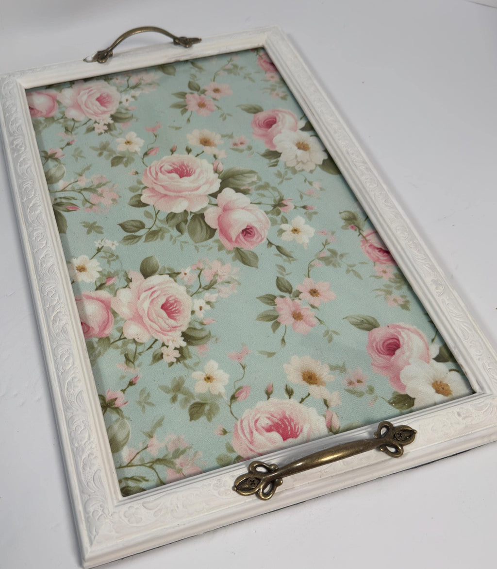 a white wooden frame with a floral pattern on the inside, which appears to be a decorative piece.