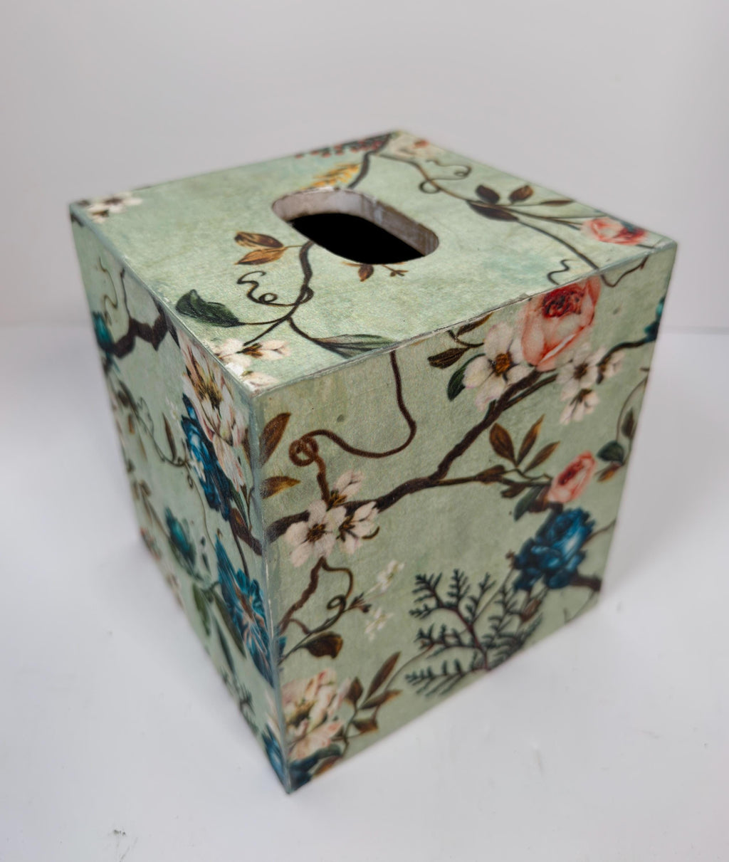 a square-shaped box with a floral pattern on its surface.