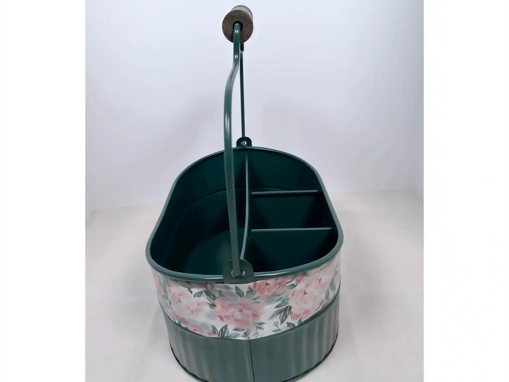 A green metal bucket with a floral pattern on the side, featuring a handle and two compartments.