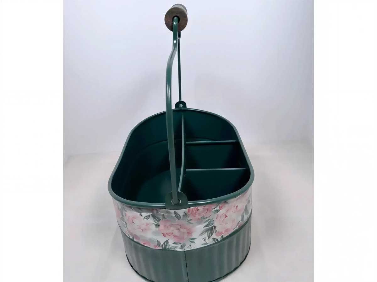 A green metal bucket with a floral pattern on the side, featuring a handle and two compartments.