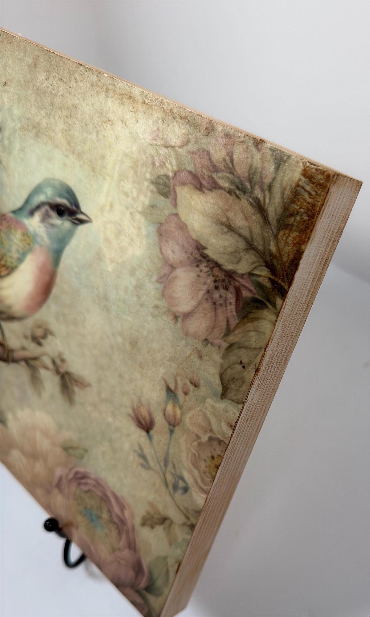 a close-up view of a wooden frame with a floral pattern on it.