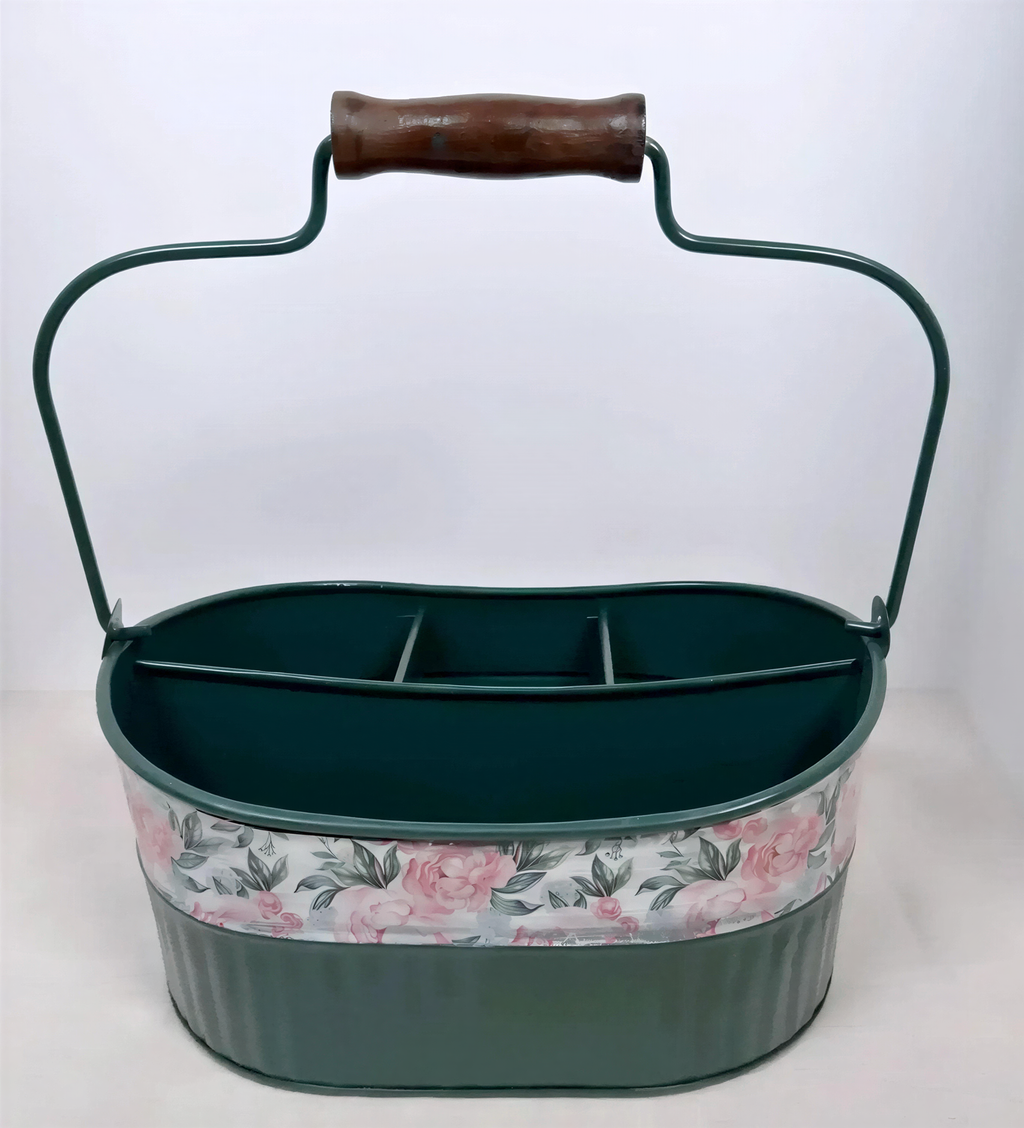 A green metal tool with a floral pattern on the front.