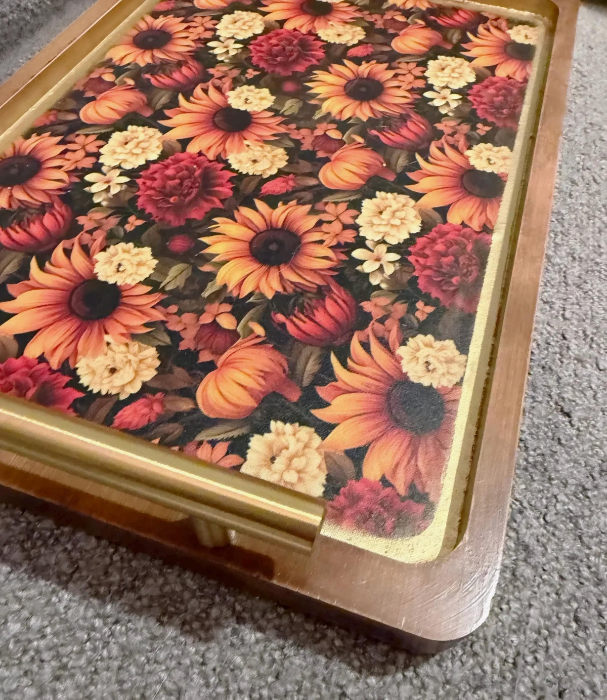 a wooden tray with a floral pattern on it.