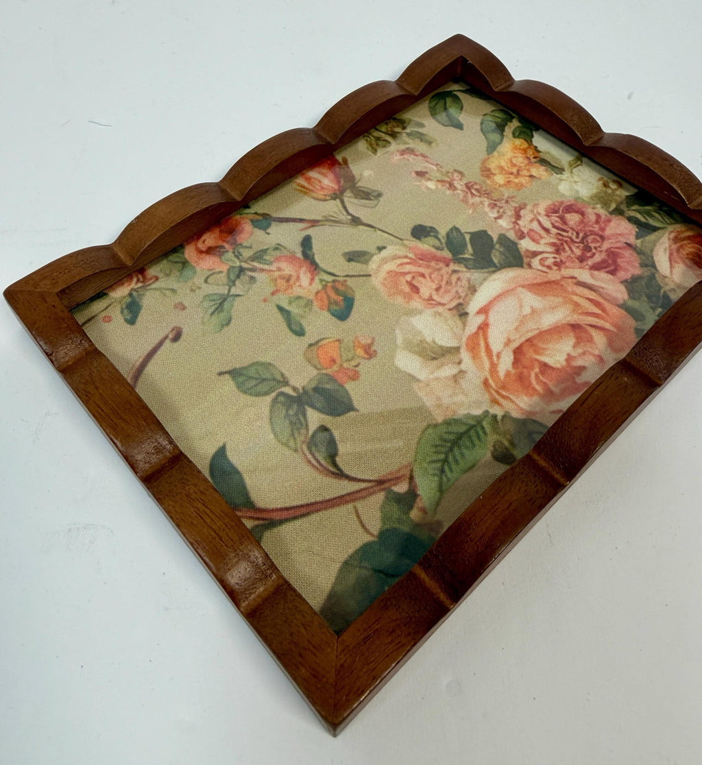 a wooden tray with a floral pattern on it.