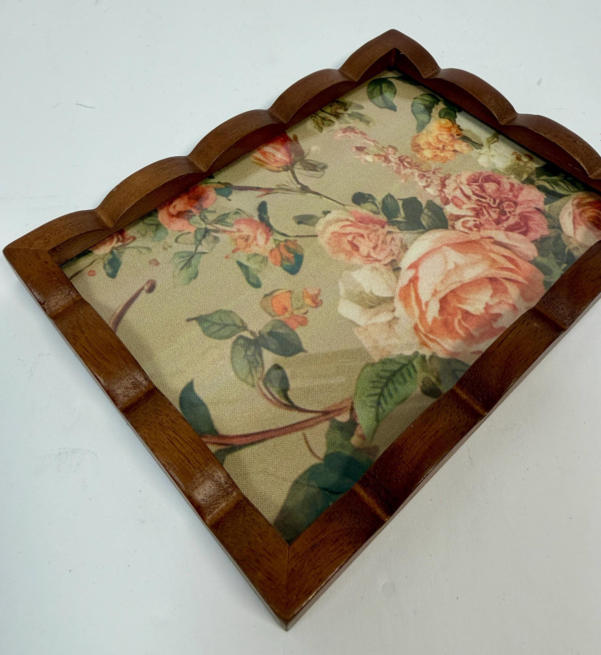 a wooden tray with a floral pattern on it.