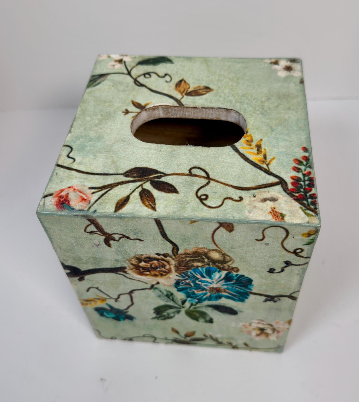 a square-shaped box with a floral pattern on its surface.