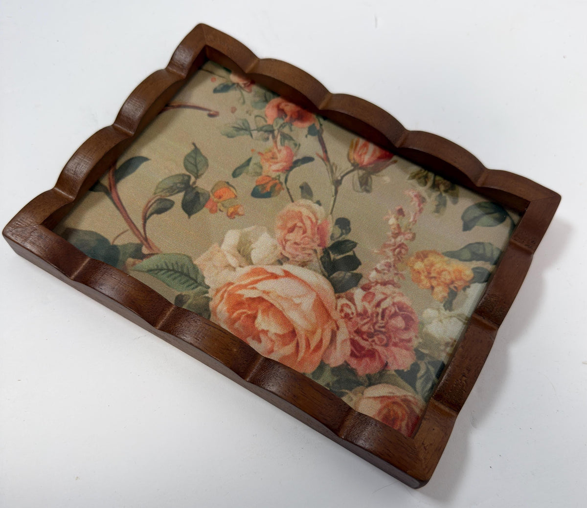a wooden tray with a floral pattern on it.