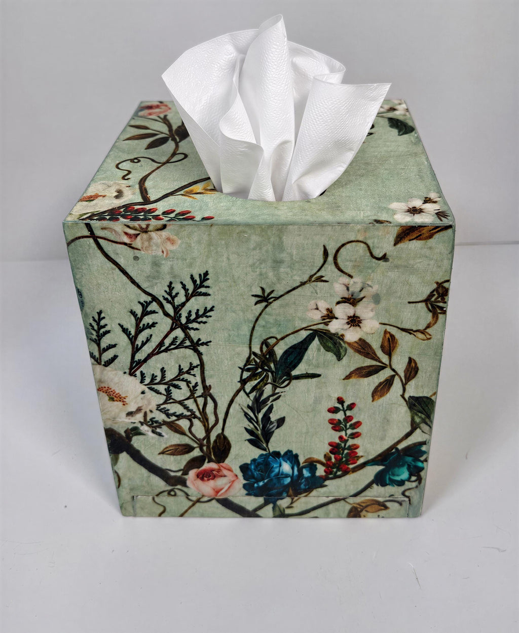 a decorative tissue box with a floral pattern on its surface.