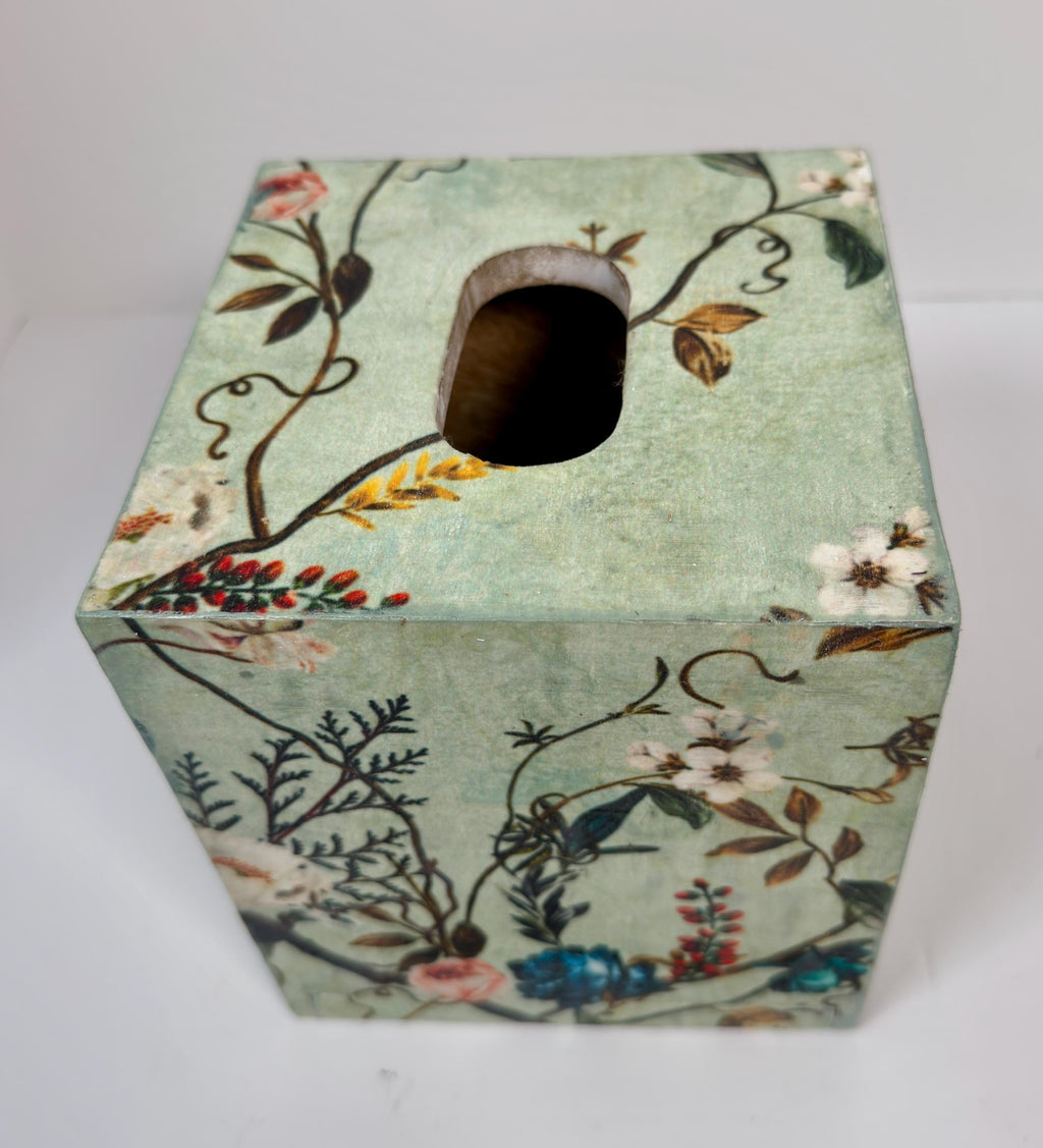 a square-shaped tissue box with a floral pattern on its surface.