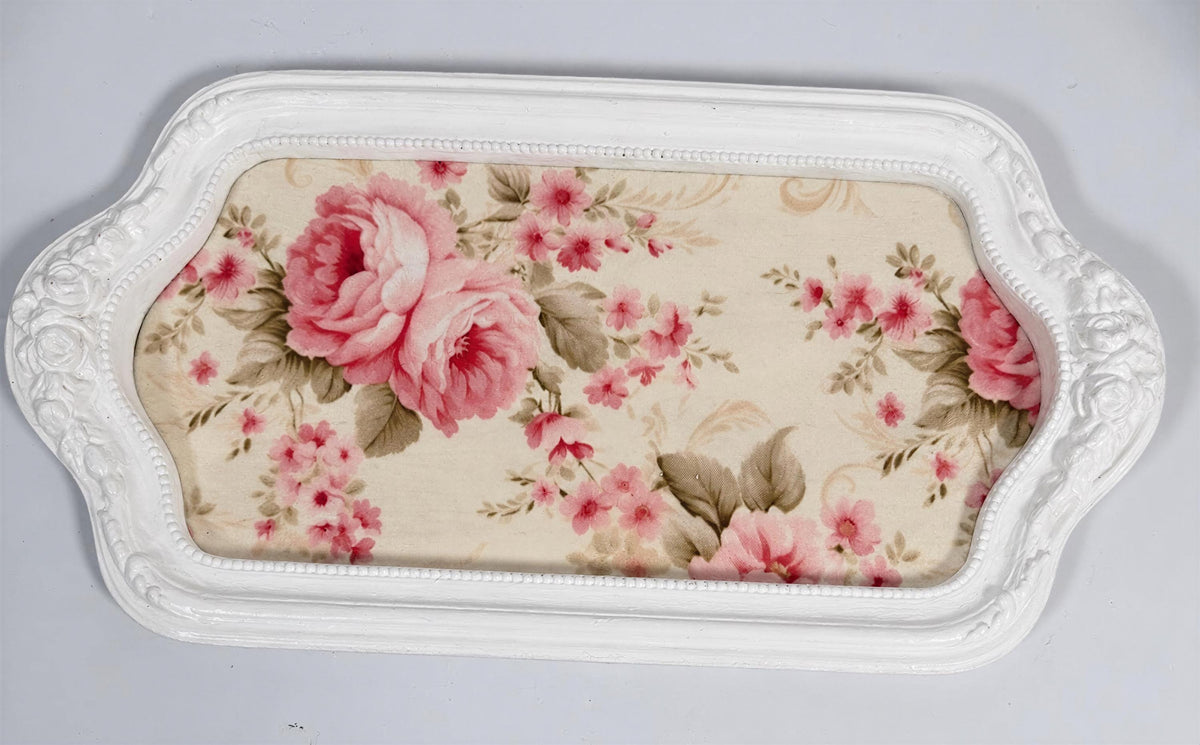 A white tray with a floral pattern on it.