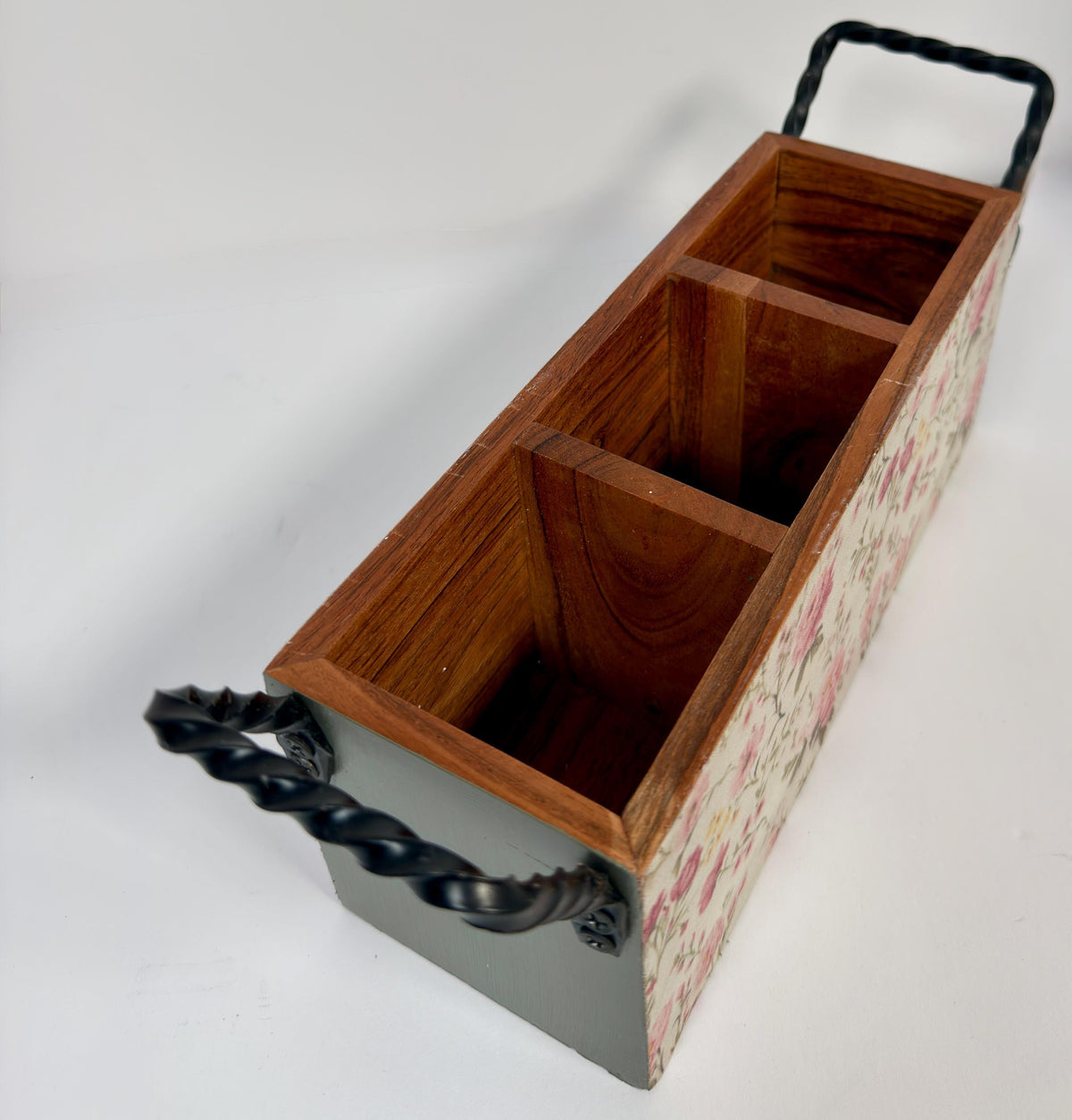A wooden box with three compartments, each with a black metal handle, sits on a white background.