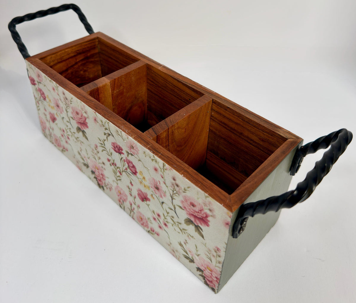 A wooden box with a floral pattern on the front, featuring three compartments.