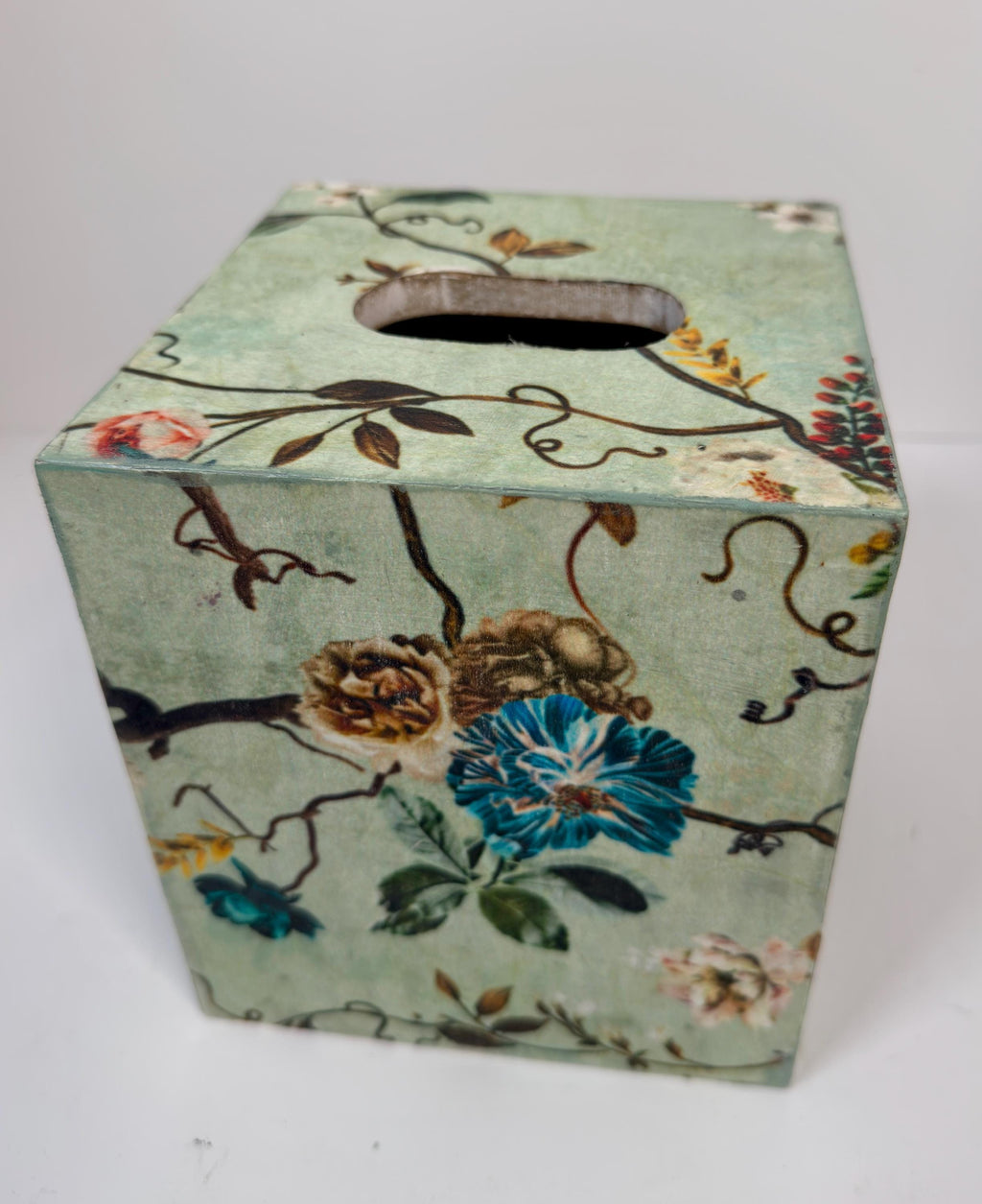 a square-shaped box with a floral pattern on its surface.