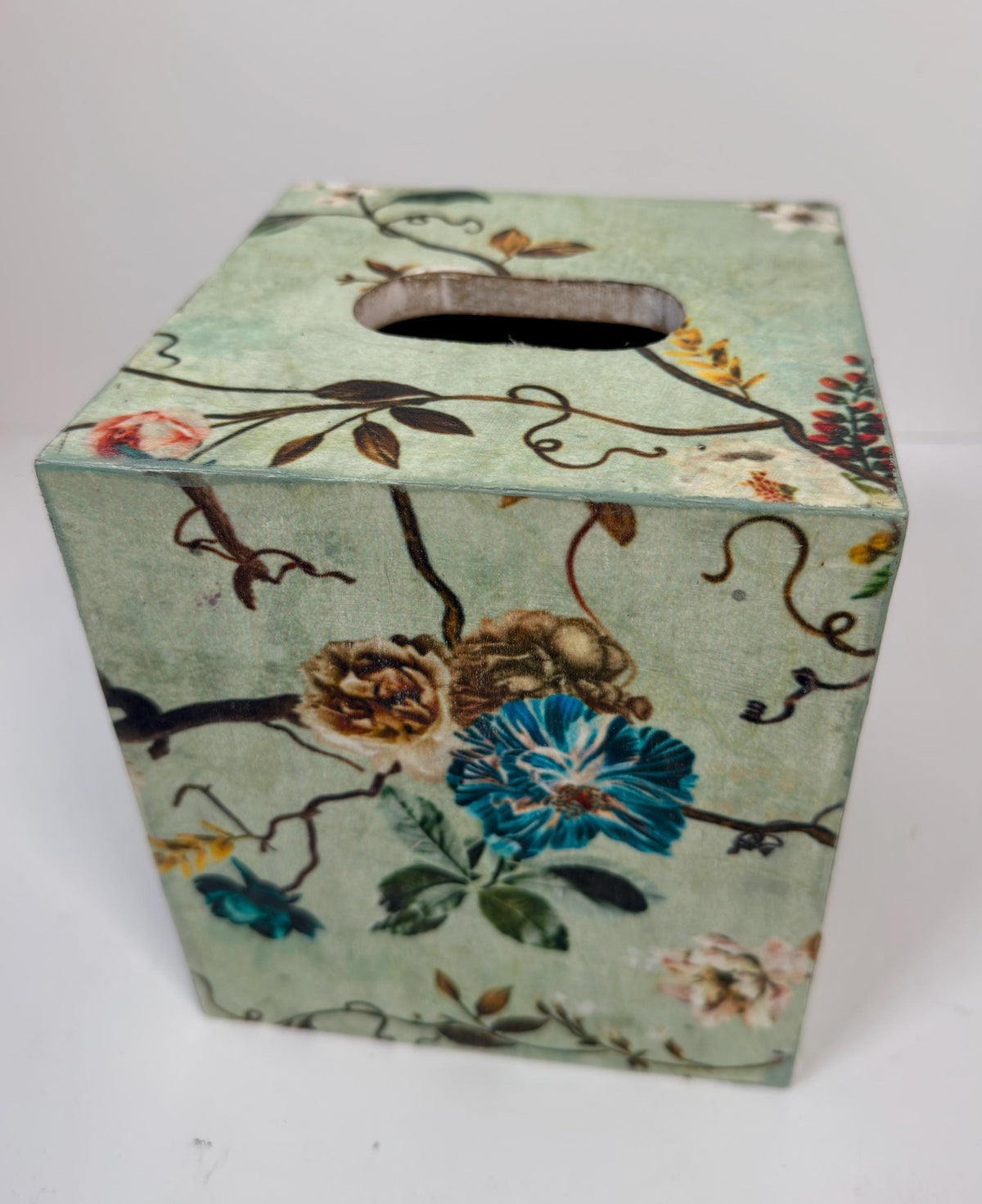a square-shaped box with a floral pattern on its surface.