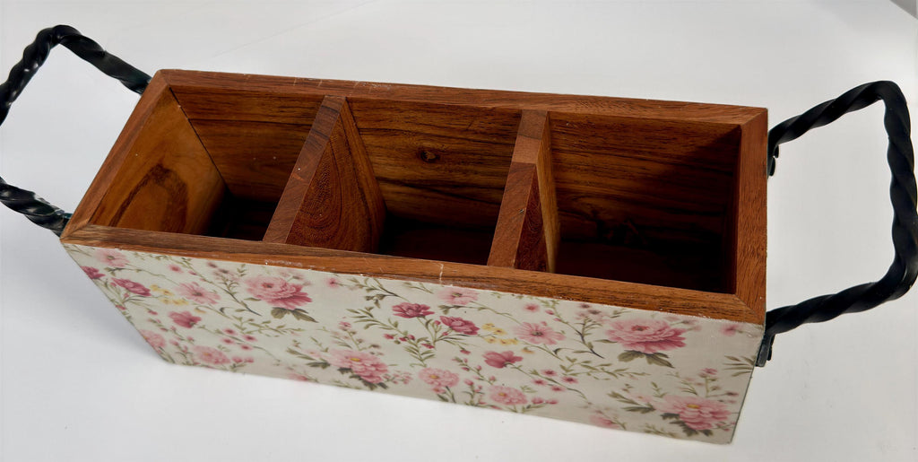 A wooden box with a floral pattern on the front, featuring three compartments.