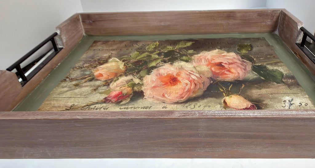a wooden tray with a painting of pink roses on it.