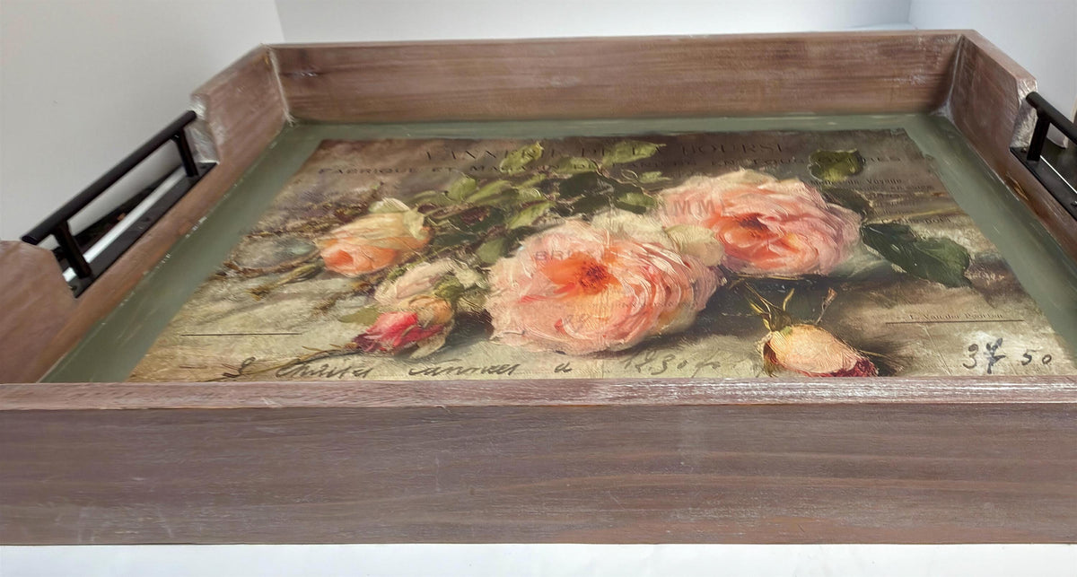 a wooden tray with a painting of pink roses on it.
