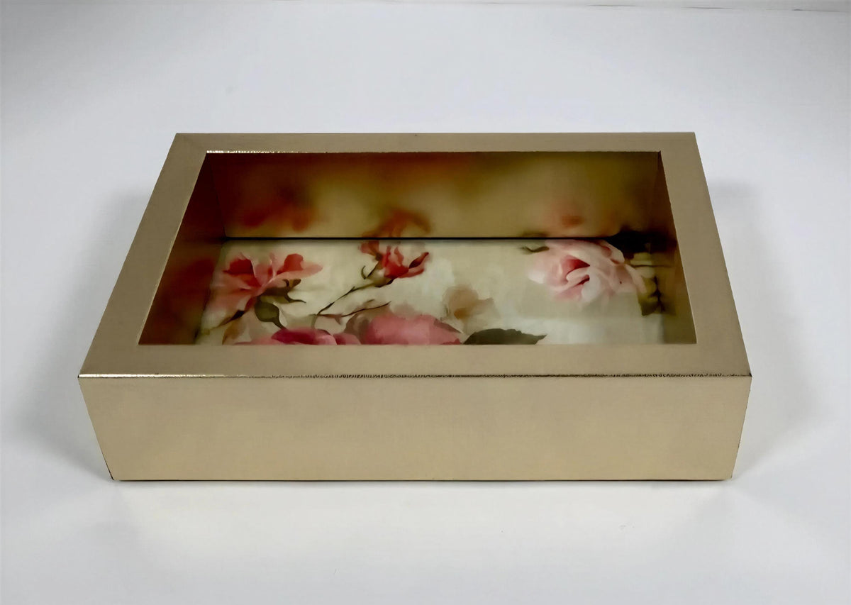 A gold-colored box with a floral design inside, featuring pink and red flowers.