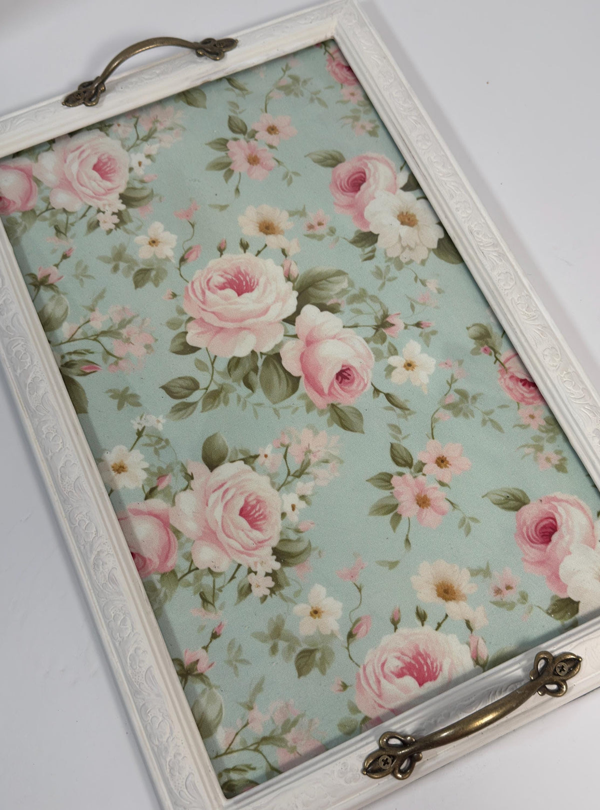 a white tray with a floral pattern on it.
