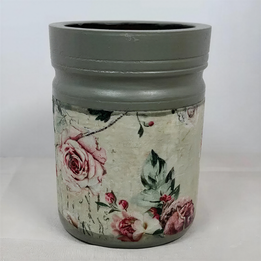 A gray vase with a floral pattern on it, featuring a combination of pink and green flowers.