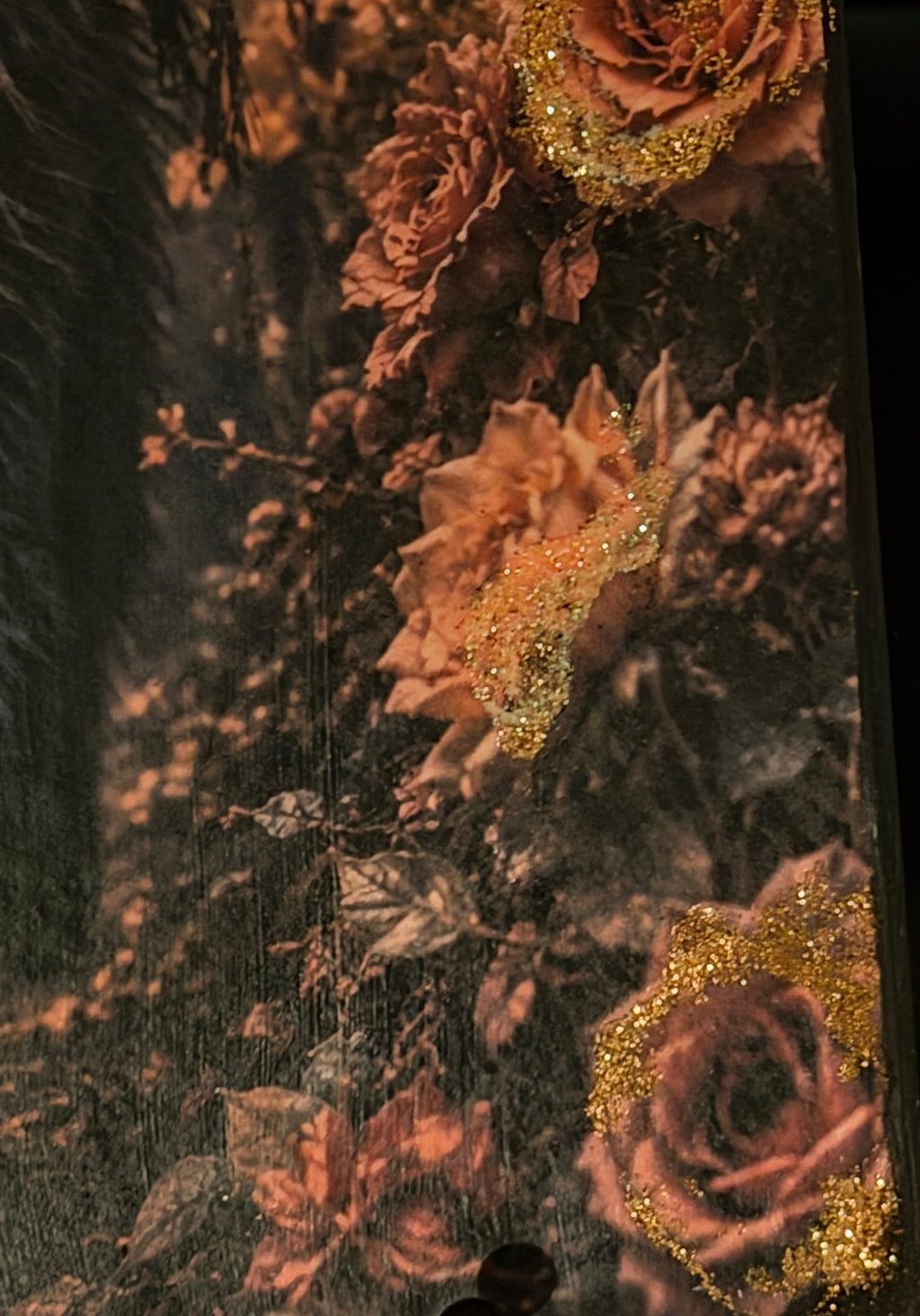 a close-up view of a vibrant floral arrangement, with a variety of pink and orange flowers adorned with gold glitter. The flowers are arranged in a way that creates a visually striking and captivating display.