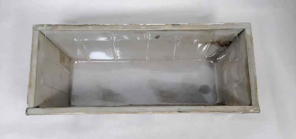 a white rectangular container with a transparent lid, sitting on a white surface.
