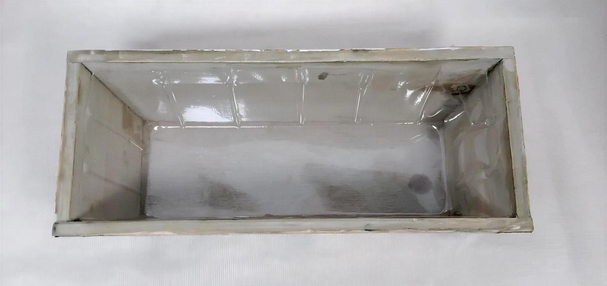 a white rectangular container with a transparent lid, sitting on a white surface.