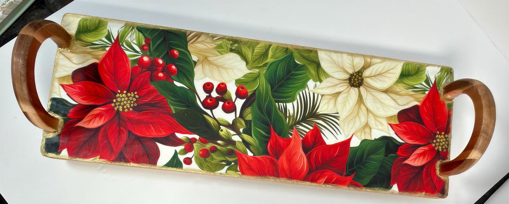 A decorative wooden tray with a floral design featuring red poinsettia flowers, green leaves, and red berries.