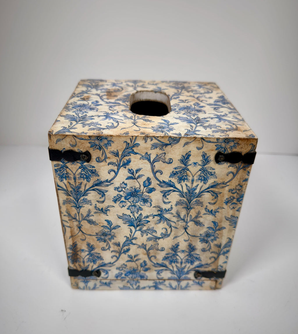 A wooden box with a floral pattern in blue and white colors.