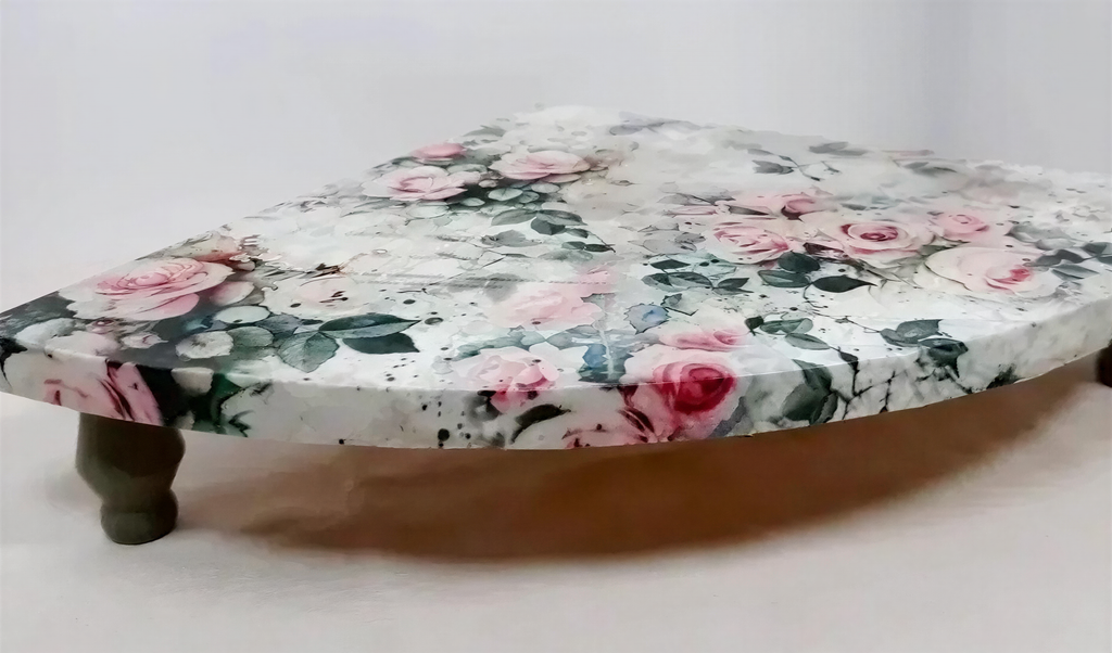 A decorative table with a floral pattern on its surface.