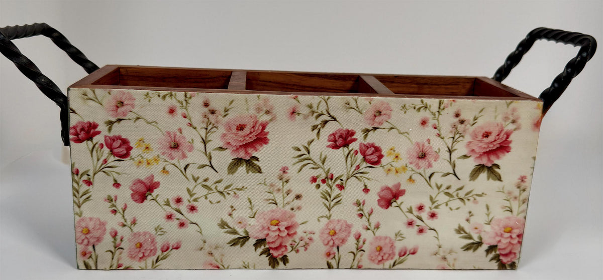 A wooden box with a floral pattern on its surface, featuring three compartments.