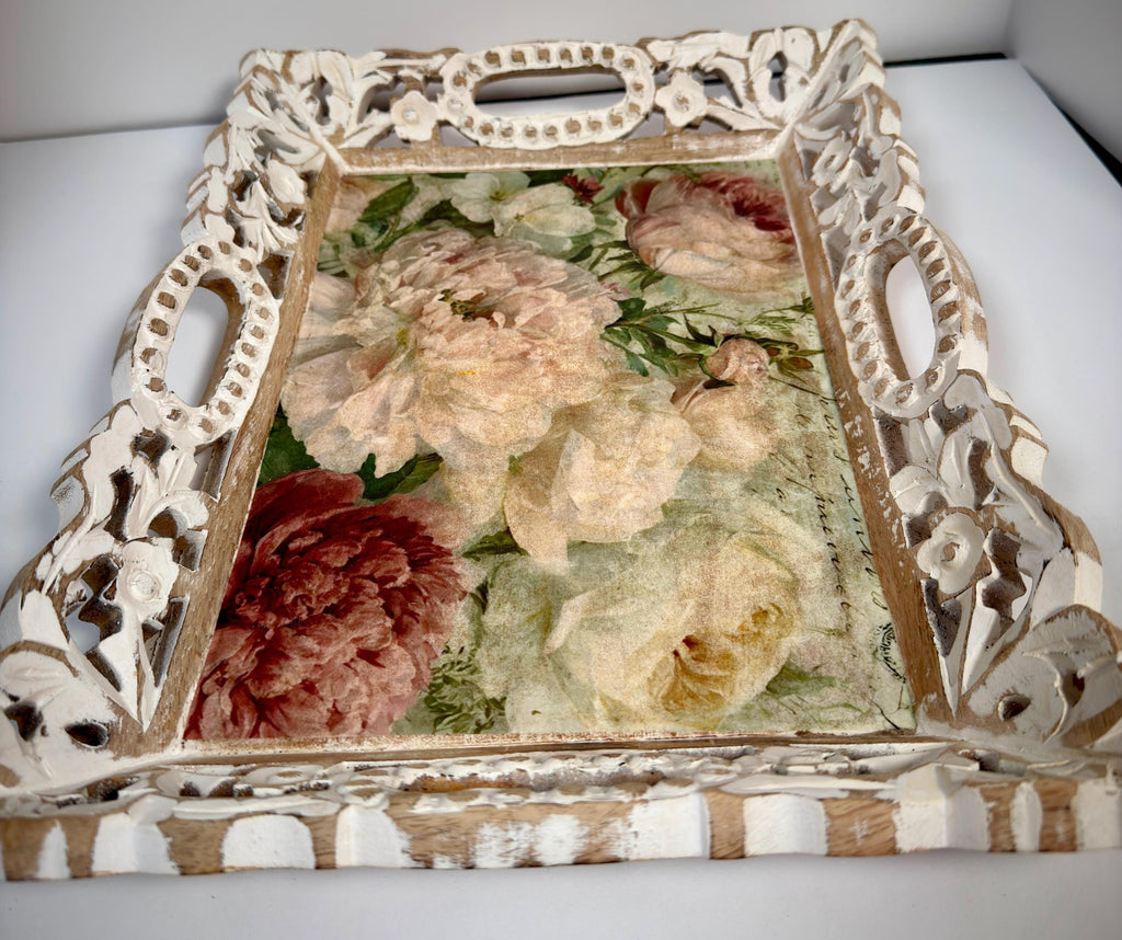 a decorative wooden tray with a floral design on it.