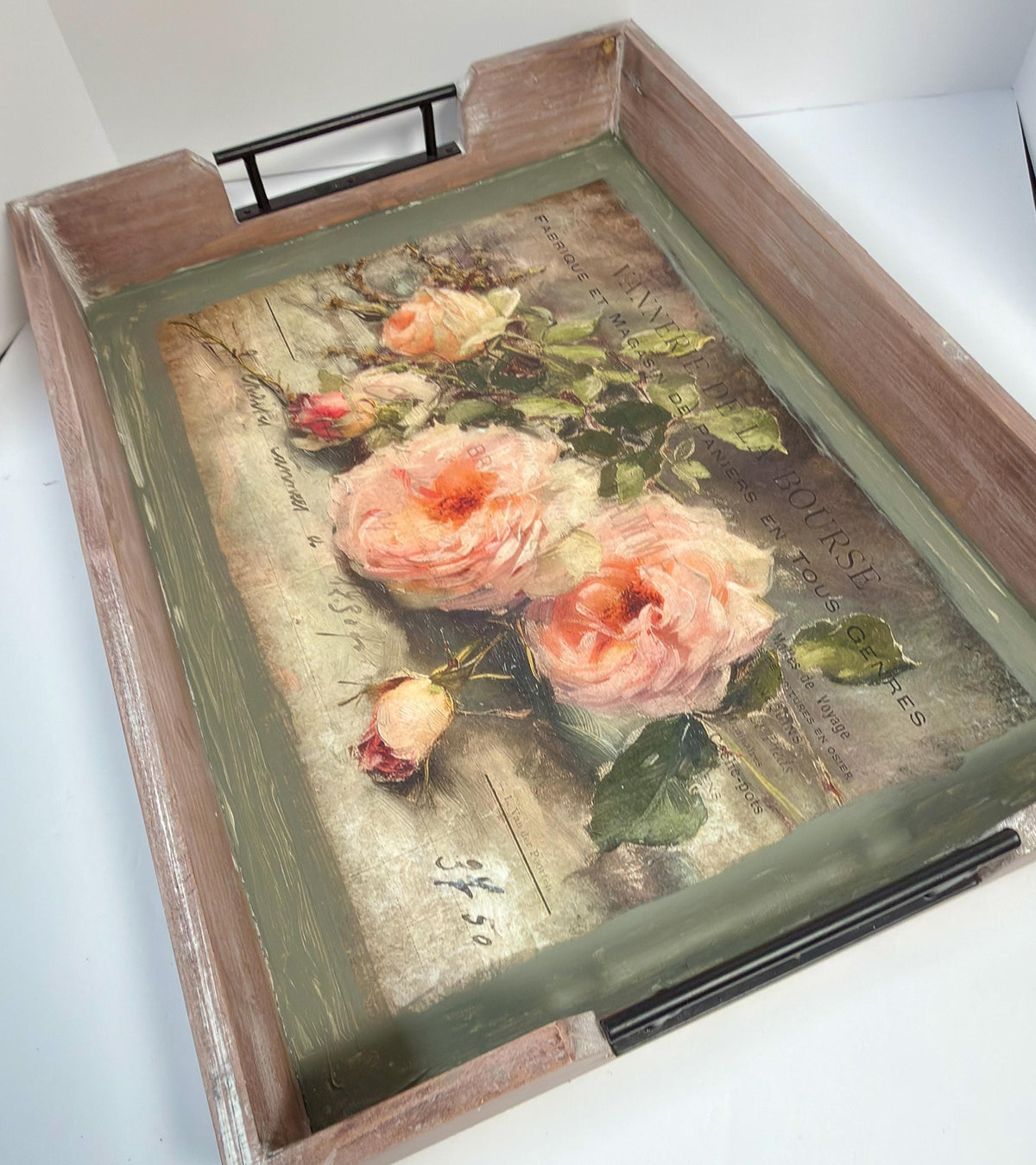 a wooden tray with a decorative floral print on it.