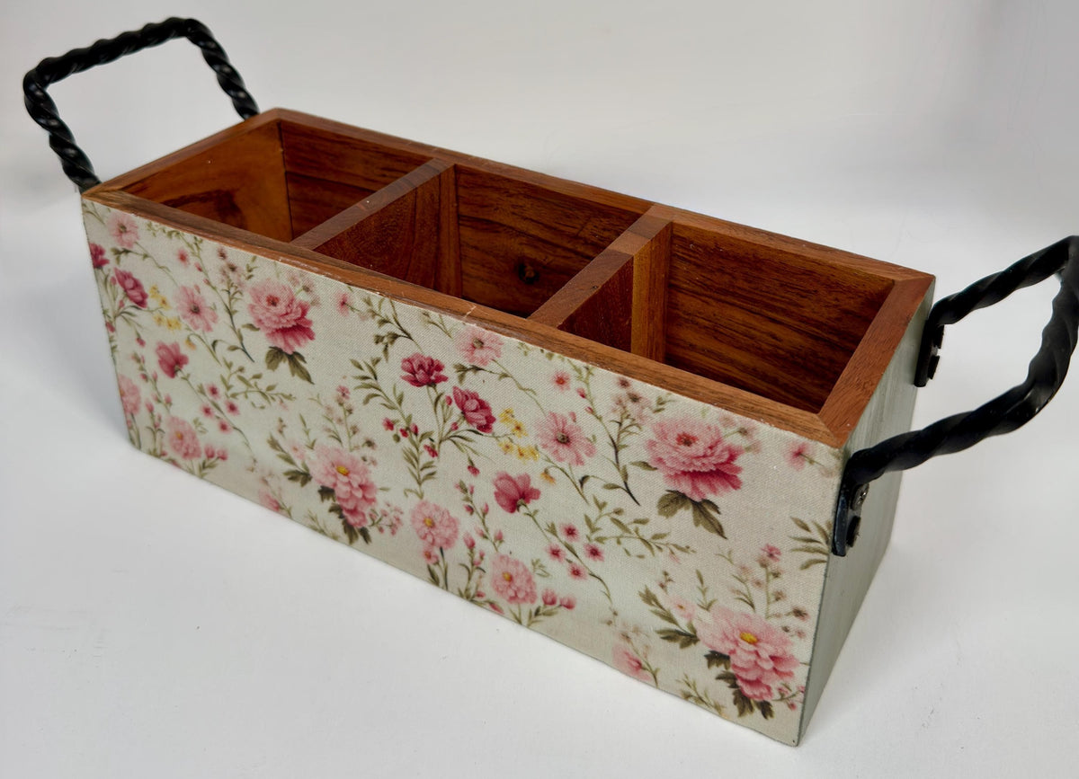 A wooden box with a floral pattern on its surface, featuring three compartments.