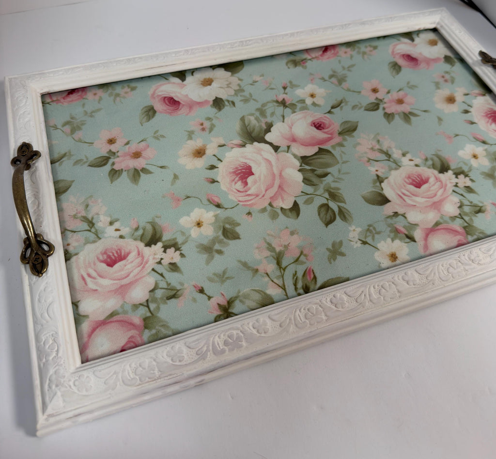A white wooden tray with a floral pattern on it.