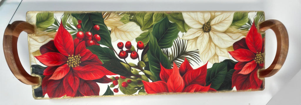 A decorative tray with a floral pattern featuring red poinsettia flowers, green leaves, and red berries.