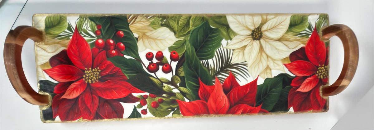 A decorative tray with a floral pattern featuring red poinsettia flowers, green leaves, and red berries.